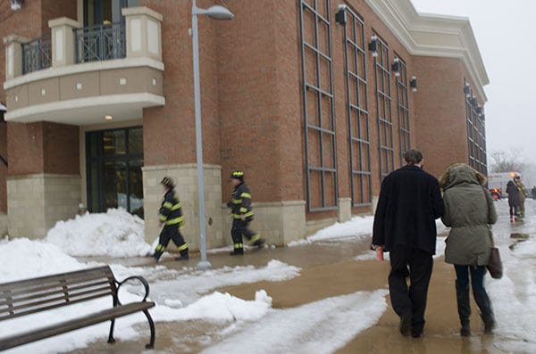 Two fire fighters enter the Smith Haven Mall through the “Lifestyle Wing,” the entrance closest to New York & Company. Many districts reported to the scene, including fire fighters from neighboring towns, to help assess the damage and to evacuate the entire mall. Photo by Heather Khalifa.