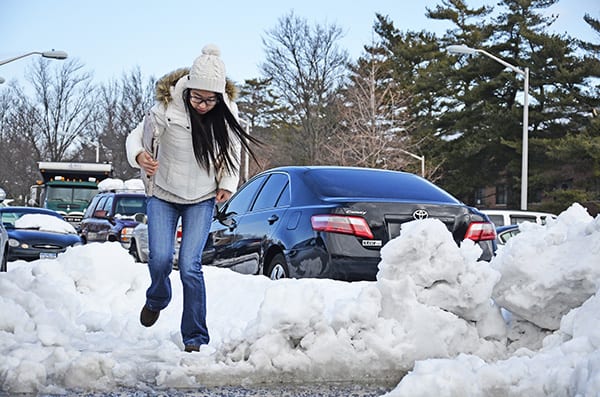 Angela Yu, a graduate student at Stony Brook University, trudges through the snow at Kenneth P. LaValle Stadiums parking lot on Tuesday, Feb. 12. The massive blizzard that hit the Northeast over the weekend dropped 28 inches of snow in Stony Brook. Photo by Nelson Oliveira.