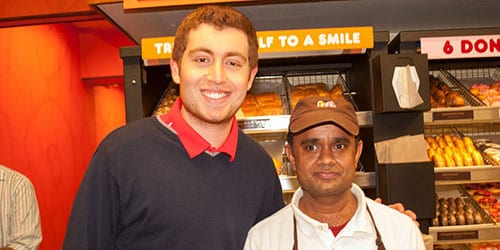 A post on the Stony Brook Compliments Facebook page inspired a group of students to express their appreication for beloved local Dunkin Donuts employee, Zamir. Above, Zamir poses with student Daniel Ahmadizadeh. (EFAL SAYED / THE STATESMAN)