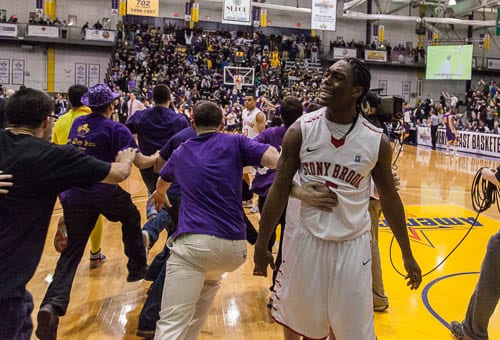 Albany fans storm the court after Stony Brooks Dave Coley missed a desperation shot at the buzzer.(EZRA MARGONO / THE STATESMAN)