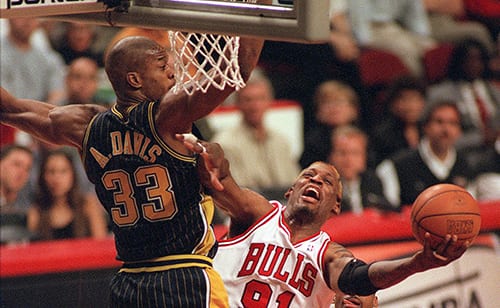 Dennis Rodman (C) tries to keep the ball away from Indiana Pacers Antonio Davis (L) during 2nd quarter play in Chicago, IL., Sunday.  Chicago won game 1 of the Eastern Conference final 85-79.