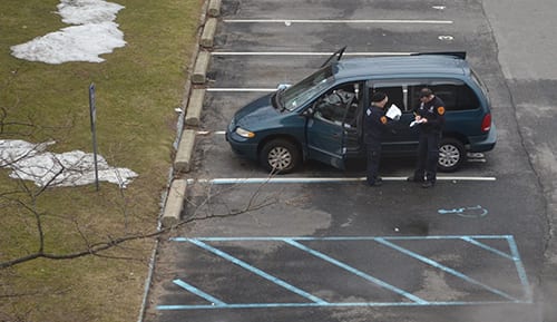 Suffolk County Police examine a van at a crime scene outside the chemistry building at Stony Brook University on Friday, March 1, 2013. (MIKE PEDERSEN / THE STATESMAN)