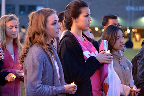 Students attend a vigil and light candles for the victims of the Boston Marathon bombings. (METSHA RENOIS/ THE STATESMAN)