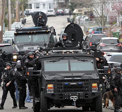 Police conduct a search for a suspect in the Boston Marathon bombings in Watertown, Massachussetts, on Friday, April 19, 2013. 