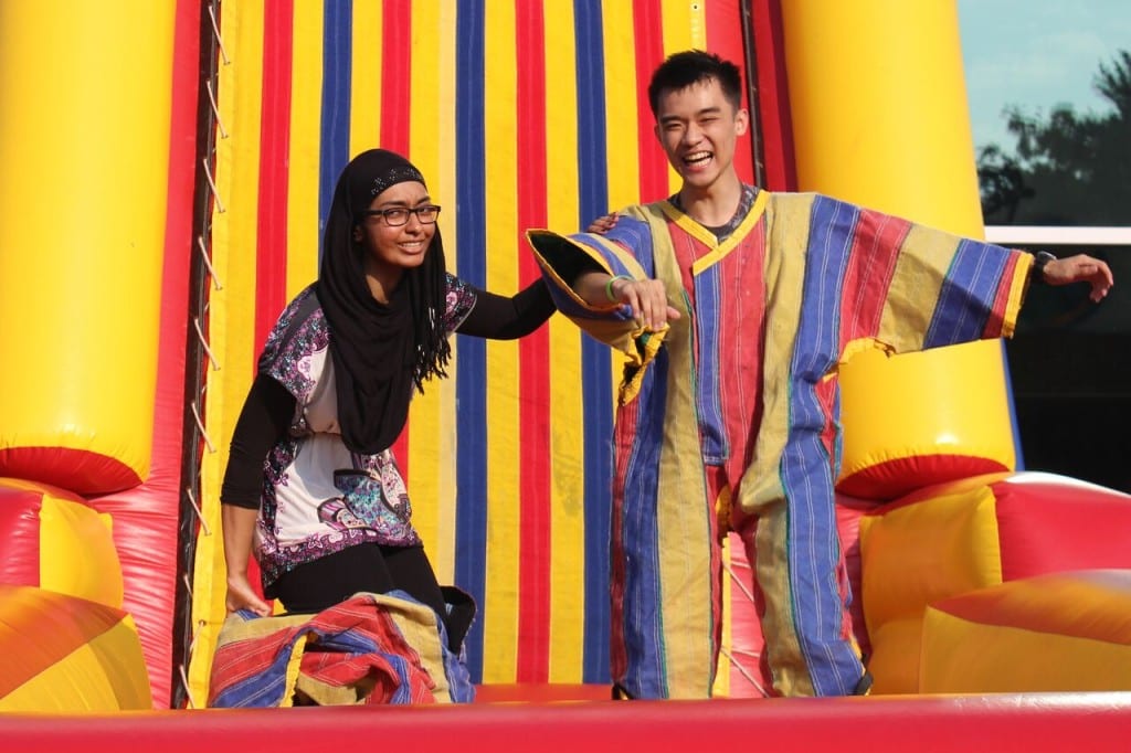 Sundas Shafique, sophomore biology major, and David Jiang, health science major, get ready to stick themselves to a velcro wall at Cirque du Brook. TAYLOR HA/THE STATESMAN