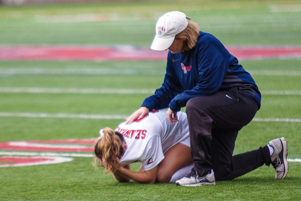 Senior midfielder Tessa Devereaux (No. 5, above) drops down to the field at Kenneth P. LaValle Stadium as then-head coach Sue Ryan consoles her following Stony Brook Women’s Soccer’s season-ending 0-1 loss on on Oct. 26 against UMBC.KRYSTEN MASSA/THE STATESMAN