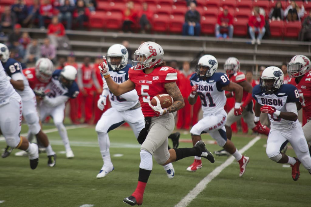 Stony Brook wide reciever Donavin Washington (No.5, above) rushes after a punt served by Howard University during Saturdays non-conference football game.  CHRISTOPHER CAMERON/STATESMAN FILE