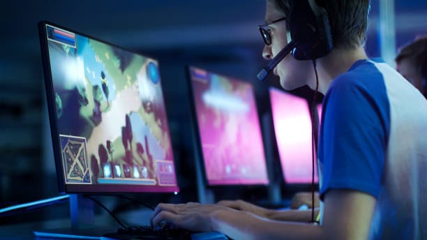 Team of Professional eSport Gamers Playing in Competitive MMORPG/ Strategy Video Game on a Cyber Games Tournament. LYNCCONF GAMES/FLICR VIA CC BY 2.0