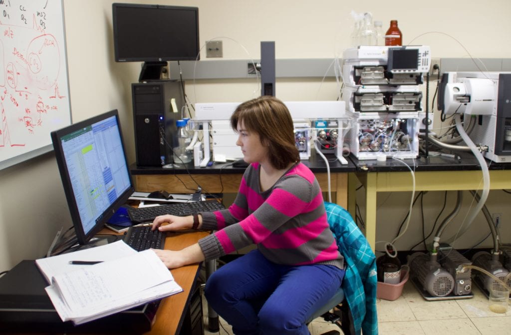 Alexandra Peterson, a senior biochemistry major and research assistant in the Basic Science Tower on East Campus, analyzes the finding of samples run through a mass spectrometer machine.   EMMA HARRIS/THE STATESMAN