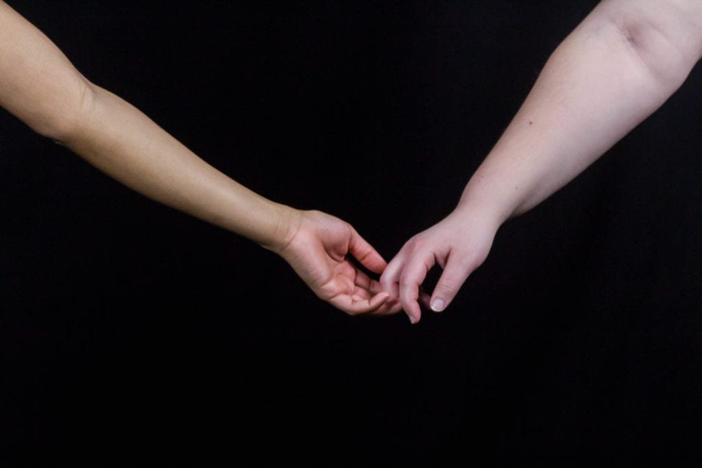 Two women hold hands. EMMA HARRIS/STATESMAN FILE