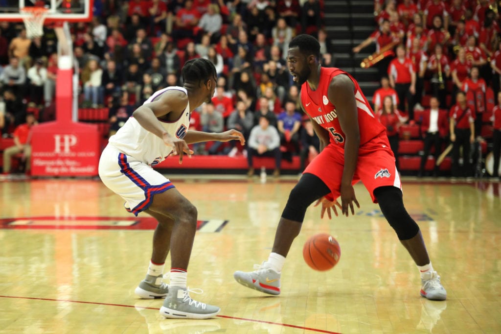 Red-shirt junior forward Akwasi Yeboah passes the ball between his legs during the game against UMass Lowell on Feb. 9, 2019. EMMA HARRIS/THE STATESMAN