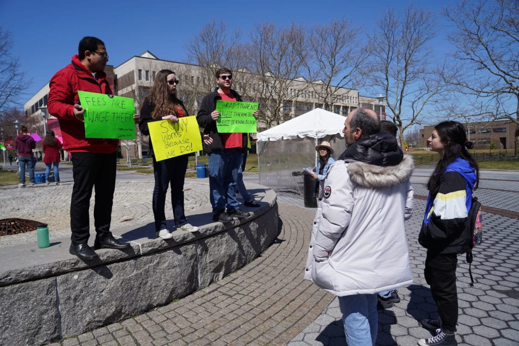 Graduate Student Employees Union members protest increased fees during Stony Brook Universitys Admitted Students Day on Saturday, April 6, at the main fountain outside of the administration building. This year graduate student fees will increase by about $100. GARY GHAYRAT/THE STATESMAN