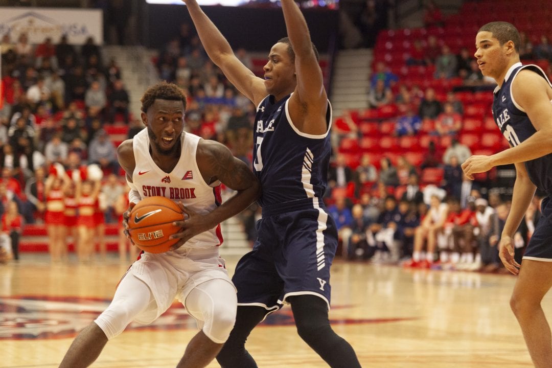 Olaniyi in with the ball during Stony Brook mens basketball home opener on Nov. 5 against Yale. 
 EMMA HARRIS/THE STATESMAN