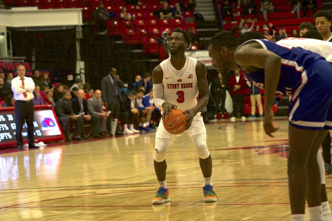 Olaniyi getting ready to throw the ball during the Stony Brook Mens Basketball game against UMass Lowell on Wednesday, Feb. 5. ROYA MEHREBAKHSH/THE STATESMAN