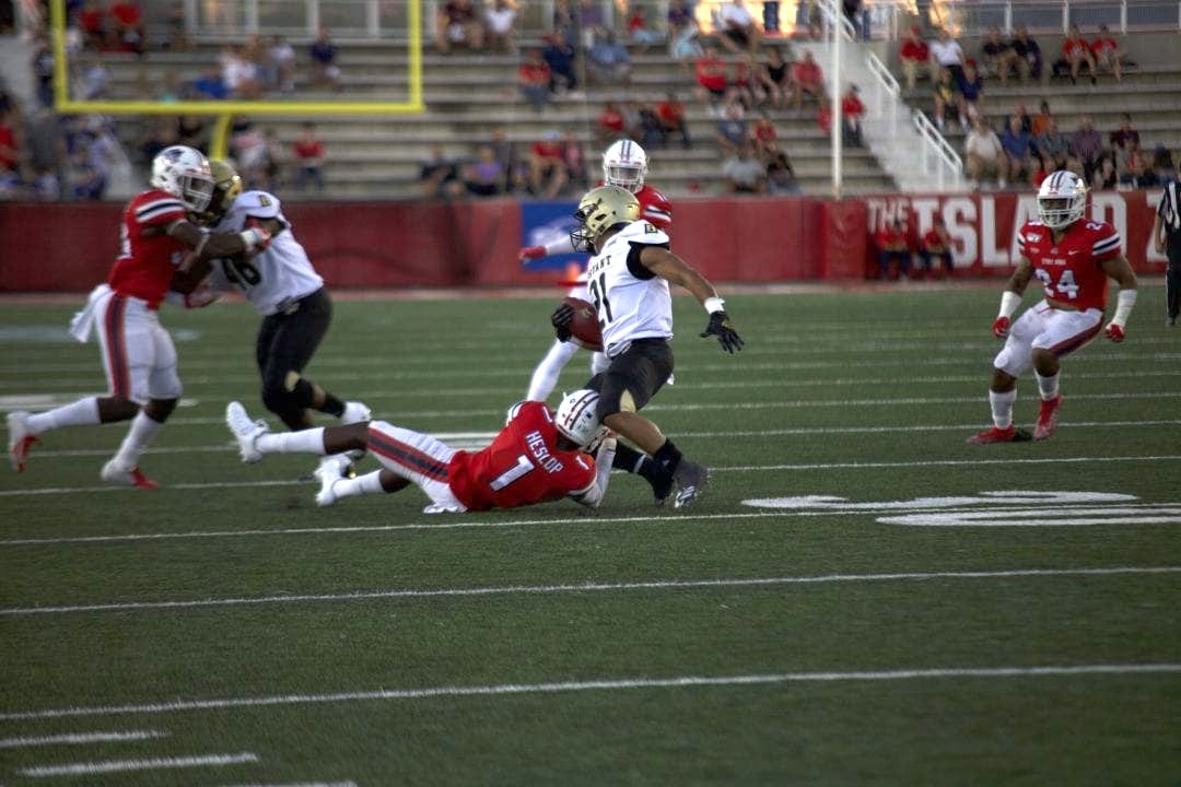 Heslop attempts to take down a Bryant football player in the Stony Brook Football home opener on Aug. 29, 2019. EMMA HARRIS/THE STATESMAN