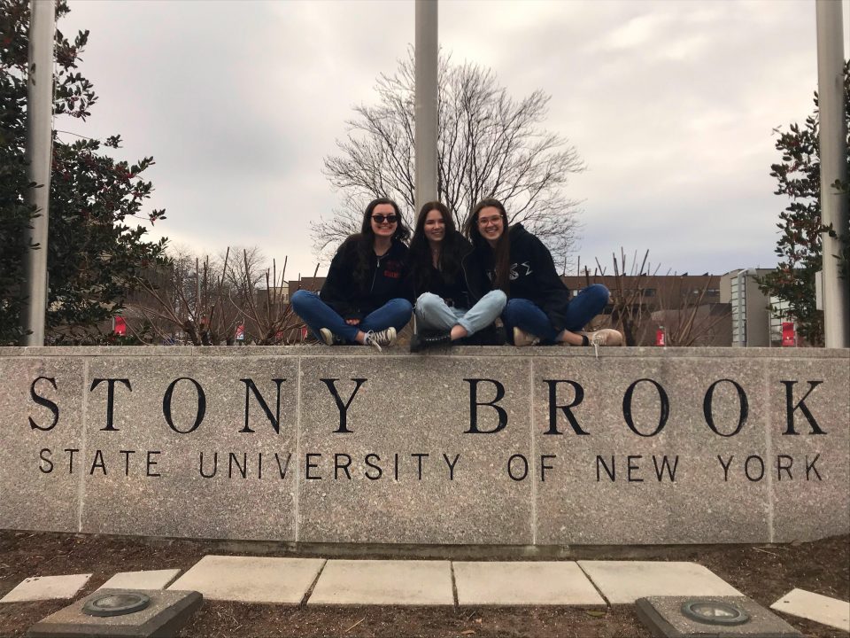 Senior Melanie Fales (left) poses with her friends Anna Young (center) and Rachel Goralski on the Stony Brook University sign before they left campus for the semester. Fales is the last theatre major at Stony Brook University.  PHOTO COURTESY MELANIE FALES
