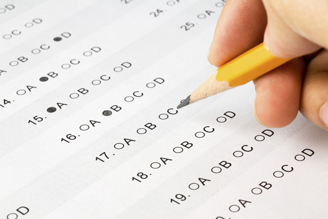 A person completing a multiple choice exam. ALBERTO G//FLICKR VIA CC BY SA 2.0