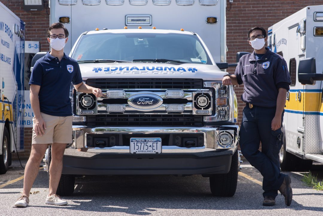 Zachary Davidson, Vice President of Stony Brook Volunteer Ambulance Corp (SBVAC) and Nikhil Bamarajpet, the President of SBVAC stand in front of one of their three ambulances.