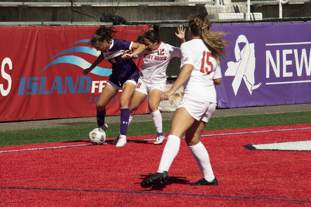 Graduate midfielder Chelsie Deponte fights for the ball in a game against Albany on Sept. 19. Deponte scored the first goal of the game against Albany.