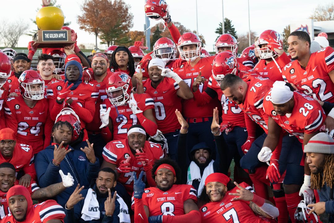 The Seawolves at the end of the game against Albany on Nov. 20 after winning the Golden Apple. They won against Albany 36-14.CAMRON WONG/THE STATESMAN