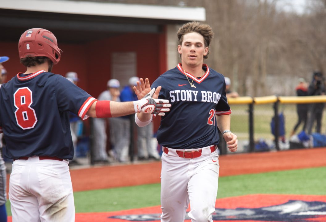 Infielder Matt Brown-Eiring and Outfielder Cole Durkan sharing a high five after a good run during the game against UMass Lowell. The Seawolves won 10-9 at game 3 against Lowell on March 20. ETHAN TAM/THE STATESMAN
