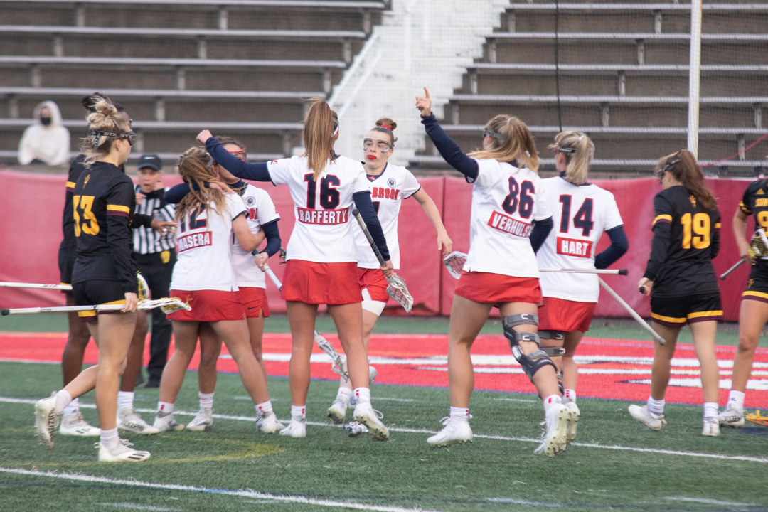 The Seawolves going in for a hug after a goal was scored against Arizona on April 1. They won 16-4 against Arizona. AMAYA MCDONALD/THE STATESMAN