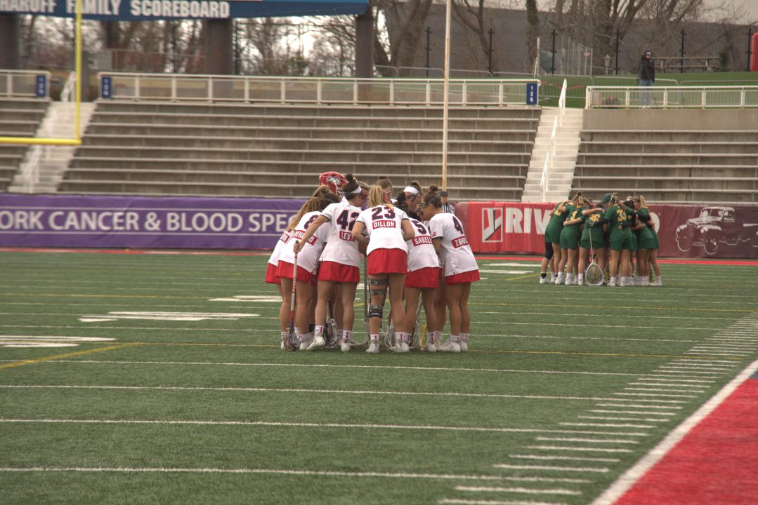 The Stony Brook womens lacrosse team huddling before a match with Vermont on March 26. The Seawolves earned the No. 8 seed in the NCAA Tournament despite an impressive resume.
