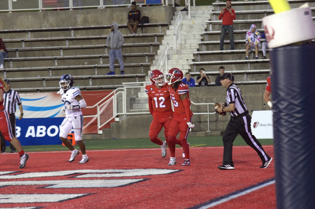 Quarterback Charlie McKee and wide receiver Khalil Newton celebrating the game-winning touchdown against Maine on Saturday, Oct. 22. The Stony Brook football team won its first game of the season yesterday in its homecoming game. CAMRON WANG/THE STATESMAN