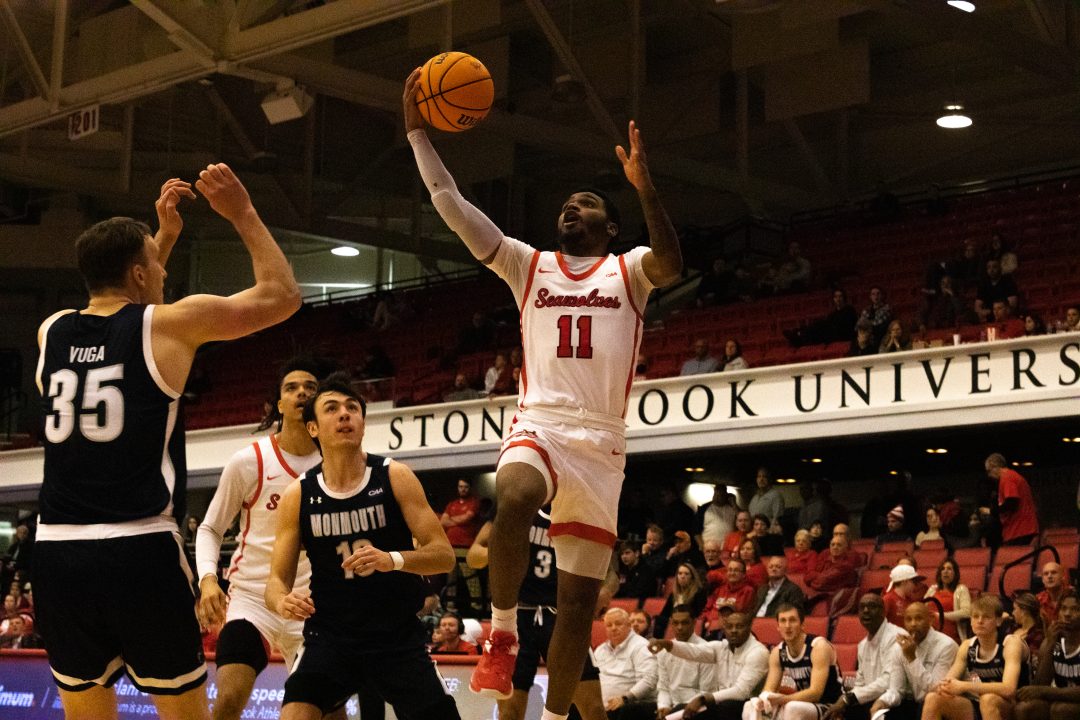 Guard Tanahj Pettway attempting a layup through contact against Monmouth. Pettway had one of the best games of his career as the Stony Brook mens basketball team beat North Carolina A&T on Saturday. VIKRAM SETHI/THE STATESMAN