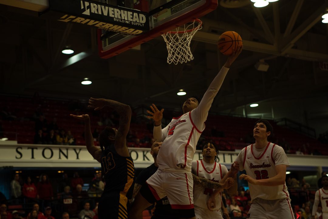 Forward Frankie Policelli going up for a layup against Hofstra on Feb. 10 while guard Tyler Stephenson-Moore and center Keenan Fitzmorris prepare for a rebound. Policelli posted another double-double as the Stony Brook mens basketball team wrapped up a poor regular season on Saturday. ABRAR NAVEL/THE STATESMAN