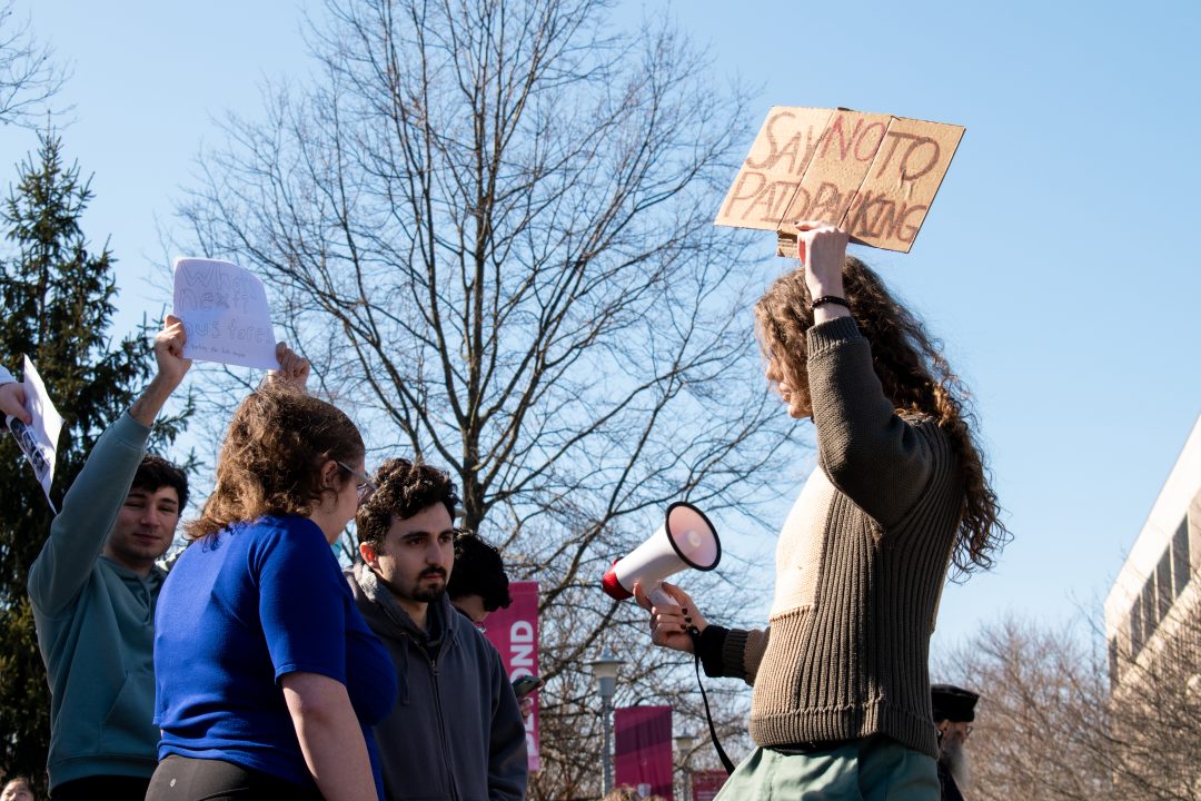 Junior physics major Chris Clarke leading a protest on Feb. 15. After MAPS unveiled their measures to switch to all-paid parking, students quickly retaliated through social media and in-person dissent. TIM GIORLANDO/THE STATESMAN