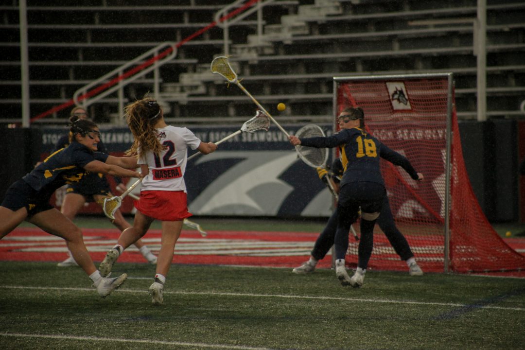 Midfielder Ellie Masera taking a shot against Michigan on Friday, Feb. 17. Masera scored four goals in the Stony Brook womens lacrosse teams opening day win over the Wolverines. CAMRON WANG/THE STATESMAN