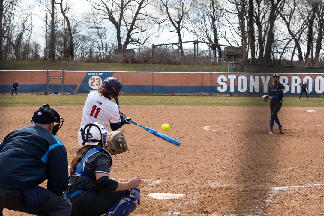Catcher Emily Reinstein hits a pitch against Hofstra on Saturday, March 18. Reinstein hit her second home run of the year on Saturday against Providence. TIM GIORLANDO/THE STATESMAN