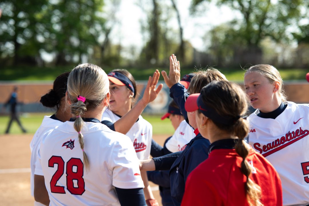 Several Stony Brook softball players and head coach Megan Bryant huddle between innings on Wednesday, April 26. The Seawolves will play the top-seeded Delaware Blue Hens in the CAA tournament on Friday afternoon. TIM GIORLANDO/THE STATESMAN