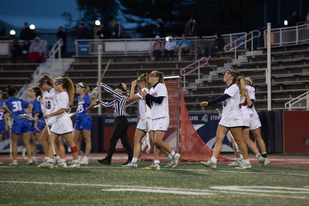 The Stony Brook womens lacrosse team celebrates a goal against Hofstra on Friday, April 28. The Stony Brook womens lacrosse team is the top seed in the 2023 CAA tournament, which will begin on Thursday. BRITTNEY DIETZ/THE STATESMAN