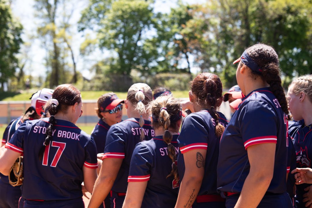 The Stony Brook softball team huddles before its game on Saturday, May 6 against Monmouth. The seventh-seeded Seawolves are waiting to see which of the three teams they will face in their next CAA playoff game tomorrow. BRITTNEY DIETZ/THE STATESMAN