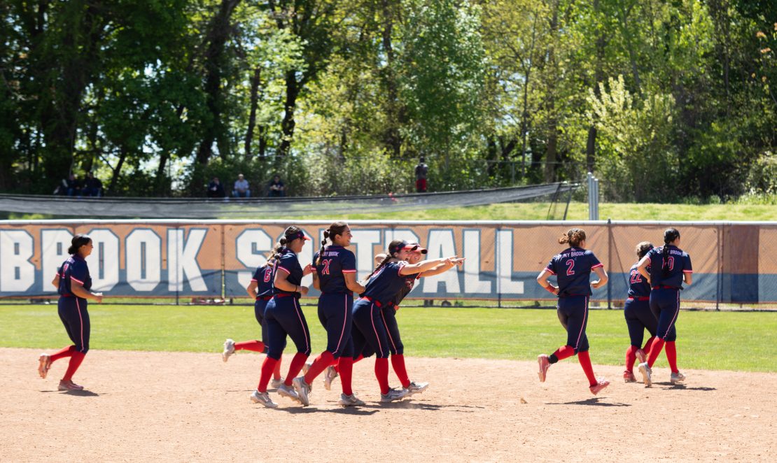 Several Stony Brook softball players celebrate a run-rule win over Monmouth on Saturday, May 6. Stony Brook enters the 2023 CAA softball tournament as the seventh seed. BRITTNEY DIETZ/THE STATESMAN
