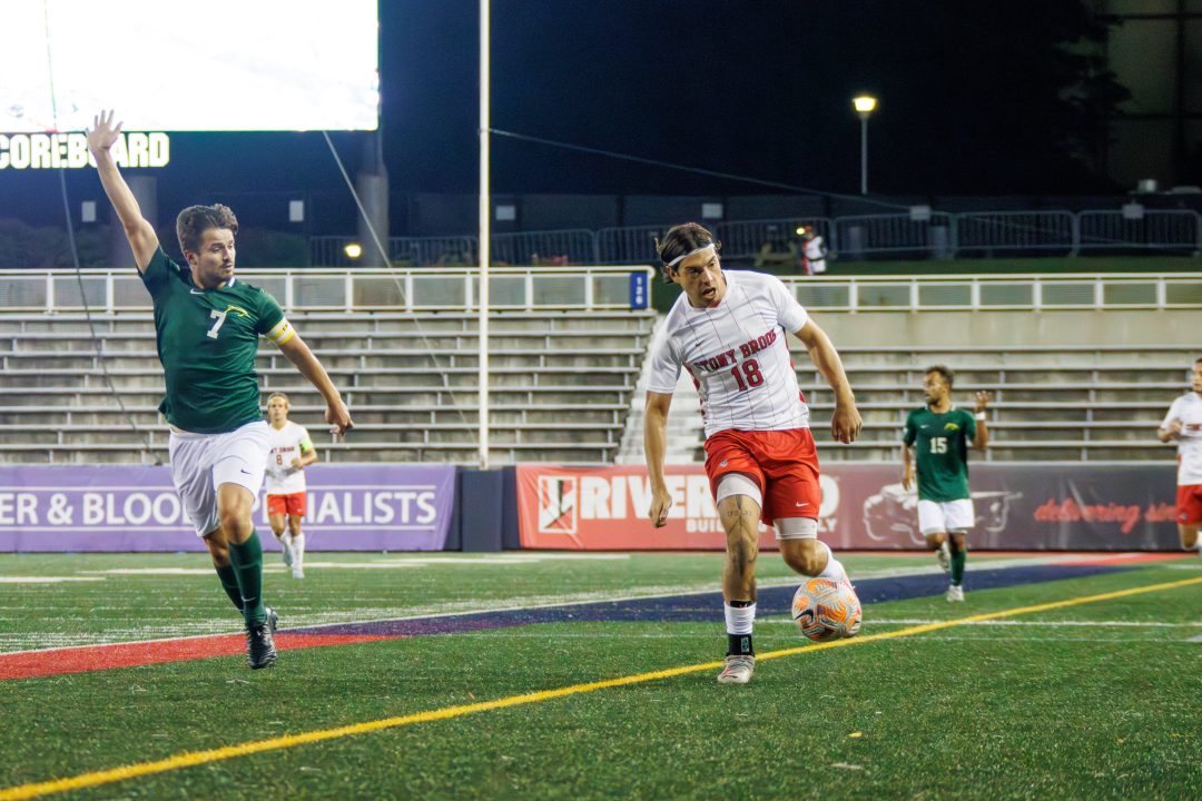 Midfielder Trevor Harrison dribbles the ball up the left wing against Le Moyne on Wednesday, Oct. 11. Harrison scored his career-high fourth goal of the season in the draw against the Dolphins. STANLEY ZHENG/THE STATESMAN