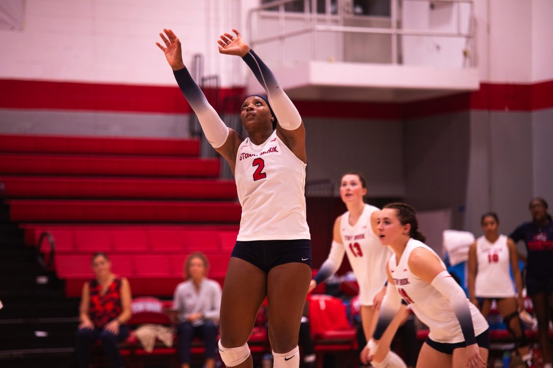 Setter Torri Henry (foreground) sets the ball up to one of her teammates against Columbia on Wednesday, Sept. 6. Henry leads the Coastal Athletic Association is assists and assists per set right now. TIM GIORLANDO/THE STATESMAN