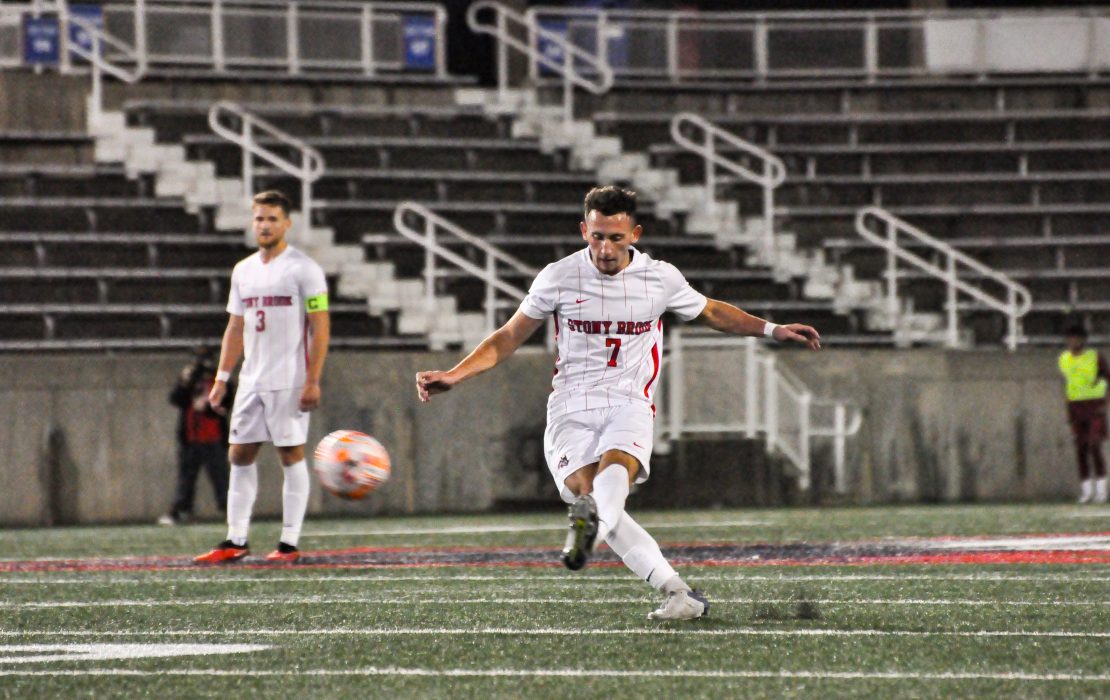 Midfielder Lorenzo Selini (foreground) sends a free kick into the box against Temple while defender Sean Towey (background) looks on. Selini and Towey will look to help shut down Monmouths top scorer on Friday. GEORGE CARATZAS/THE STATESMAN