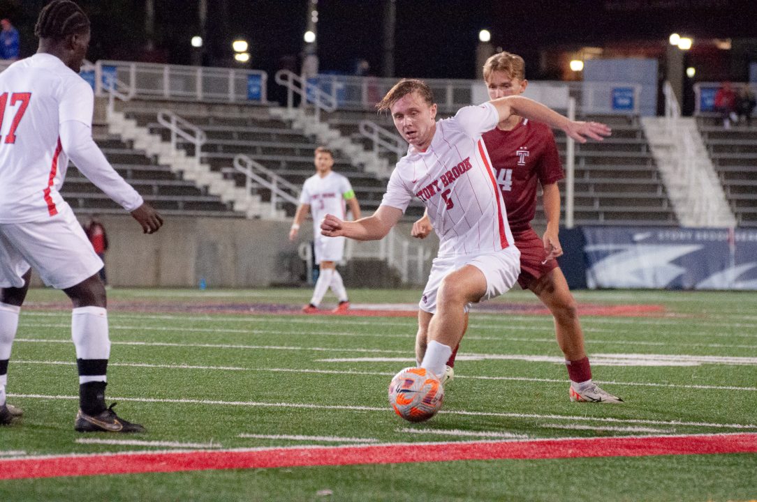 Midfielder Kyle Smith (right) passes the ball to forward Caleb Danquah (left) against Temple on Tuesday, Oct. 17. Smith scored his first career goal to win the match. GEORGE CARATZAS/THE STATESMAN