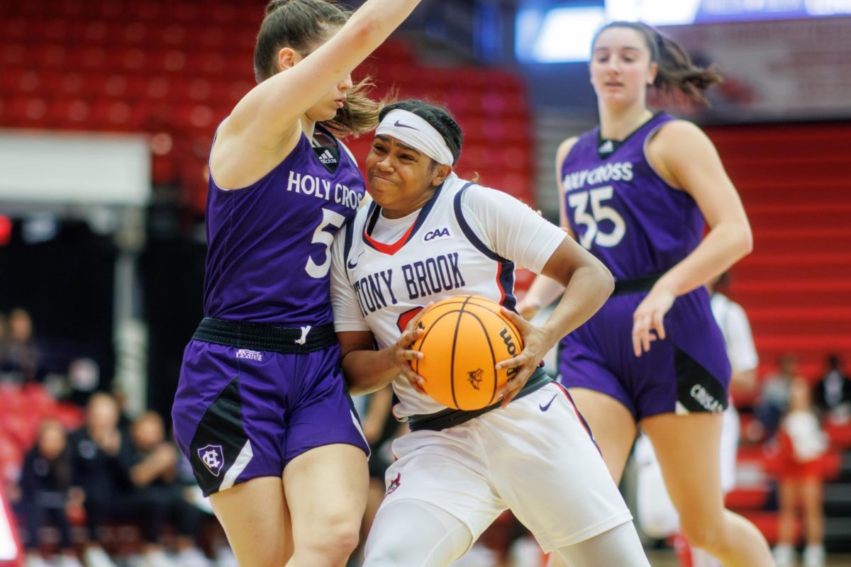 Point guard Gigi Gonzalez pushes through contact against Holy Cross on Sunday, Nov. 19. Gonzalez posted her first career double-double on Wednesday against Delaware State. STANLEY ZHENG/THE STATESMAN
