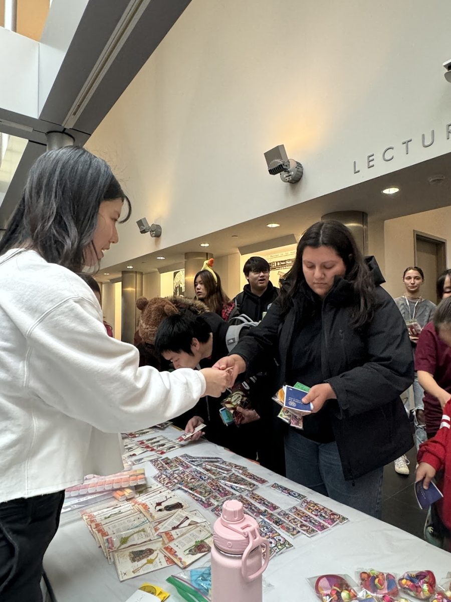 An attendee purchasing a Korean stationary item at Korean Culture Day held at the Charles B. Wang Center on Nov. 10. COURTESY OF HEEJEONG SOHN