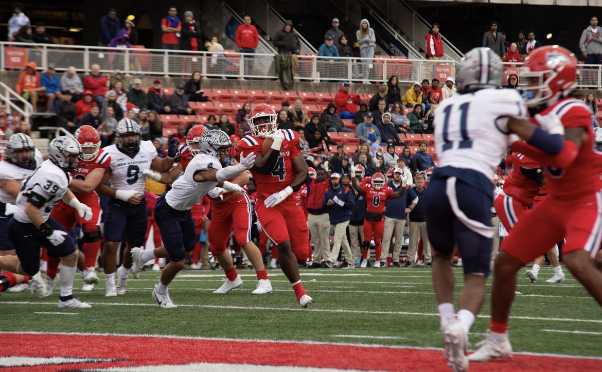 Running back Roland Dempster rushes through the left side for a touchdown against New Hampshire on Saturday, Oct. 21. Dempster had a career day in a loss at Monmouth. BRITTNEY DIETZ/THE STATESMAN