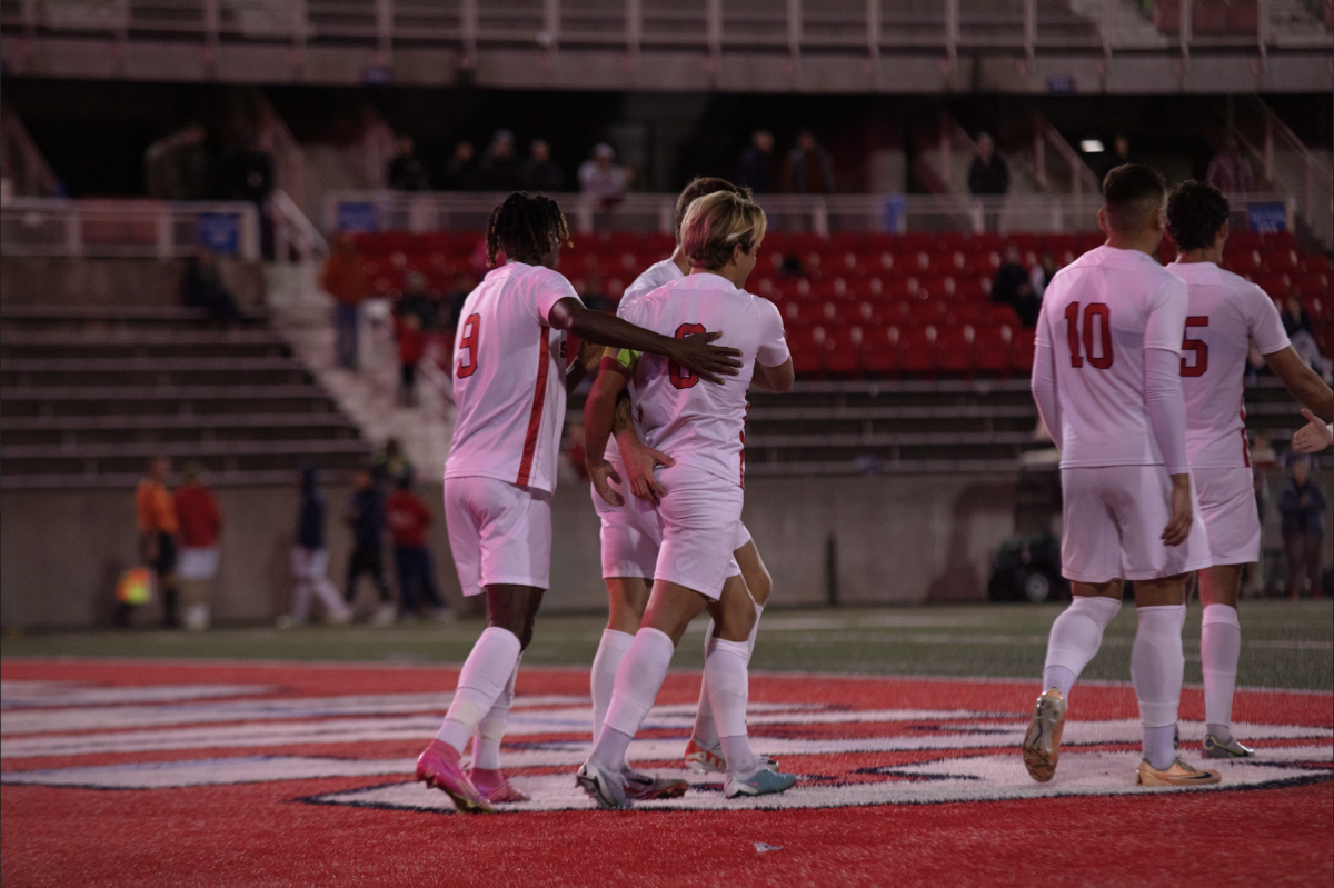 Several Stony Brook mens soccer players celebrate a goal against Lafayette on Tuesday, Oct. 24. The Seawolves will make their Coastal Athletic Association playoff debut on Thursday against Elon. GEORGE CARATZAS/THE STATESMAN