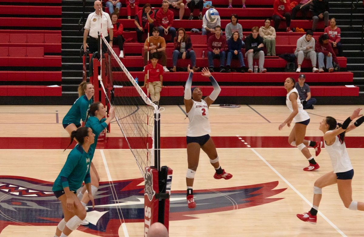 Setter Torri Henry (2) sets the ball to outside hitter Leoni Kunz (17) against the University of North Carolina Wilmington on Saturday, Nov. 4. The pair may have played their last game ever with Stony Brook after being eliminated by Towson. IRENE YIMMONGKOL/THE STATESMAN