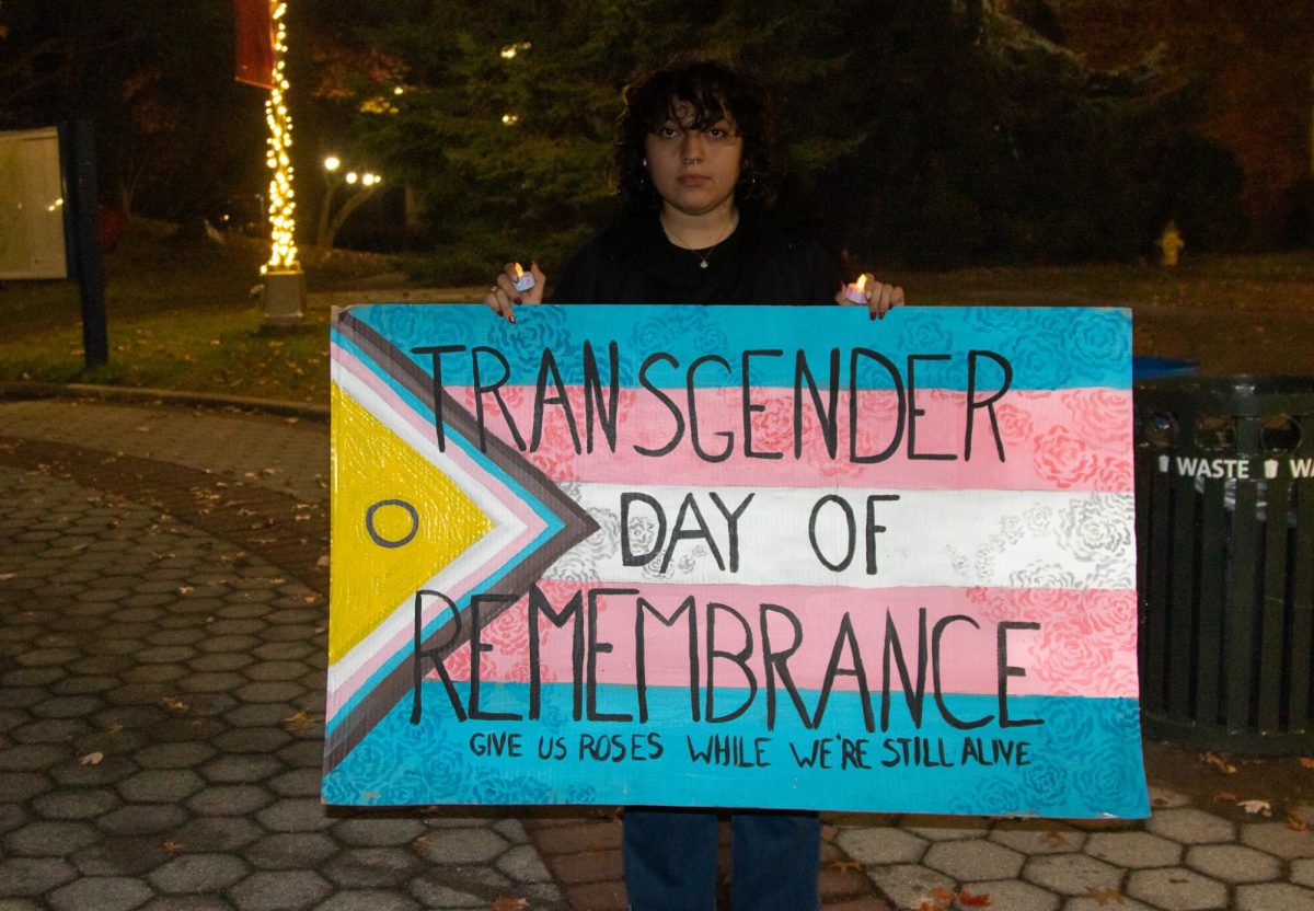 A Stony Brook student holding a sign in honor of transgender remembrance day. ISHA SHAH/THE STATESMAN