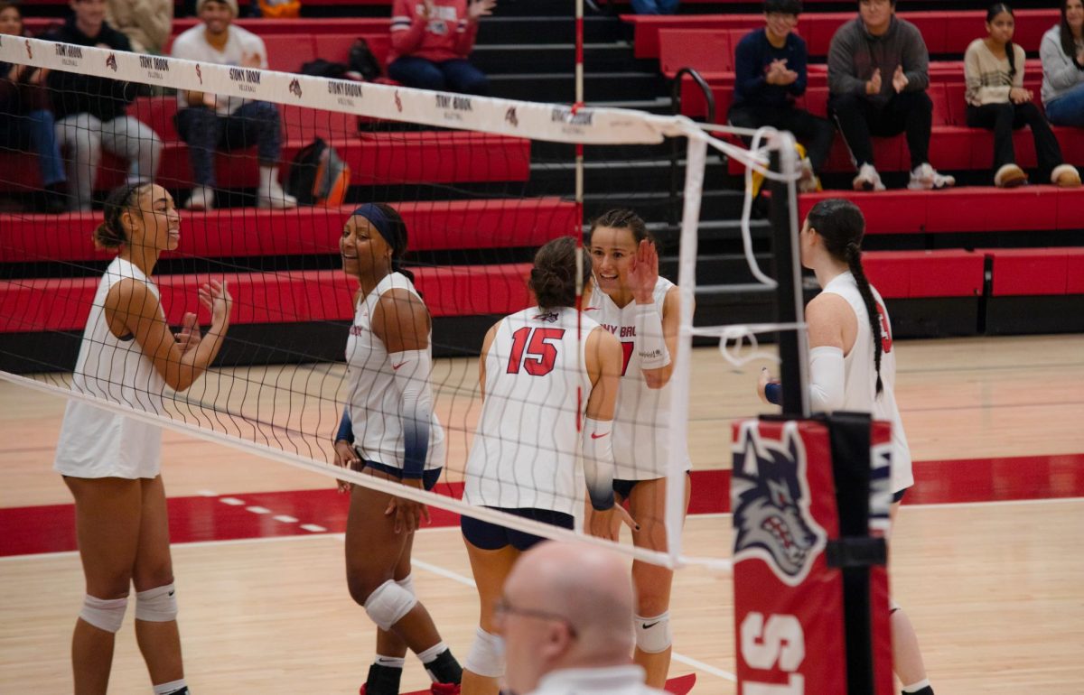 Outside hitters Kali Moore and Leoni Kunz (center) celebrate a point against the University of North Carolina Wilmington on Saturday, Nov. 4. Moore and Kunz led the Stony Brook womens volleyball team in scoring on Thursday. BRITTNEY DIETZ/THE STATESMAN