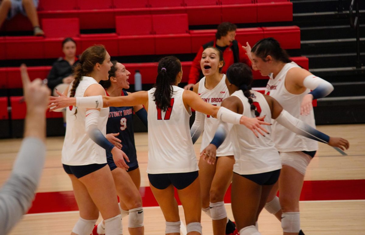 The Stony Brook womens volleyball team celebrates against the University of North Carolina Wilmington on Saturday, Nov. 4. The Seawolves will play Towson in the conference semifinal on Friday. BRITTNEY DIETZ/THE STATESMAN