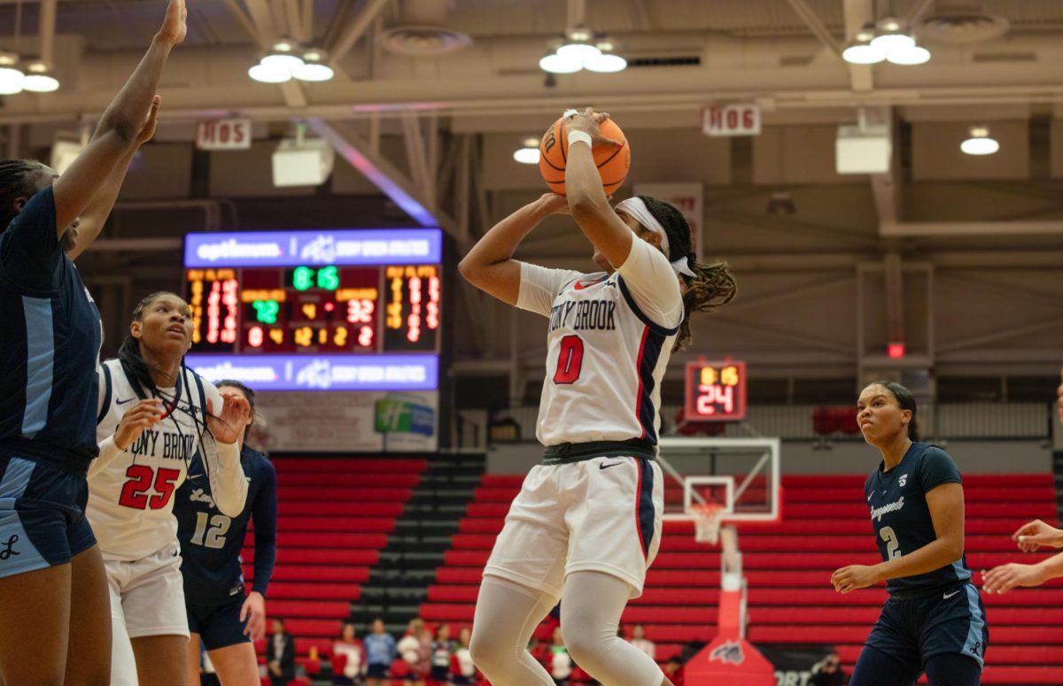 Point guard Gigi Gonzalez takes a baseline jump shot while center Khari Clark calls for the ball against Longwood on Monday, Dec. 12. The two co-led the Stony Brook womens basketball team with 16 points in the win. BRITTNEY DIETZ/THE STATESMAN